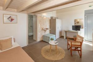 a bedroom with a bed and a table in a room at Oinoni's Home - XANTHIPI studio in Souvala
