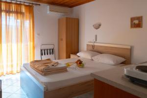 a bedroom with a bed with towels on it at HOTEL PAVLOS in Paralia Katerinis