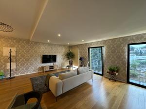 a living room with a couch and a tv at Carreira Residence in Funchal