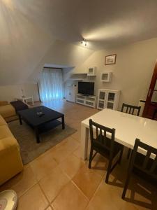 a living room with a table and a couch at Apartamento Portela in Bueu