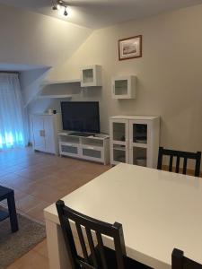 a living room with a table and a television at Apartamento Portela in Bueu +15 photos