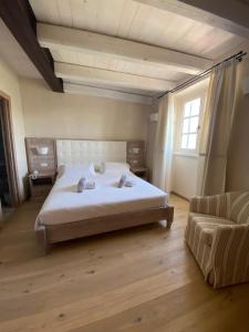 een slaapkamer met een groot bed en een bank bij Agriturismo Costa di Faraggiana in Levanto