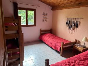 a bedroom with a bed and a bunk bed with a ladder at Maison confortable au cœur de la nature près de Camps-sur-l'Agly in Camps-sur-lʼAgly