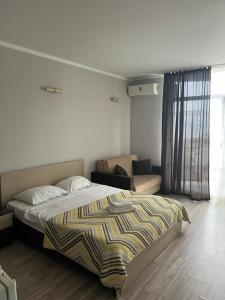 a bedroom with a bed and a couch at Orbi Sea Towers Batumi in Batumi