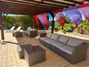 a patio with a couch and tables and flags at Aurora Sol in Luz