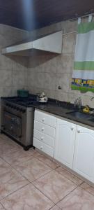 a kitchen with a stove and white cabinets at Don Manuel in Santa Rosa