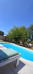 a bench sitting next to a blue swimming pool at Don Manuel in Santa Rosa