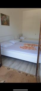 a large white bed in a room at Pipo apartmentS in Ulcinj