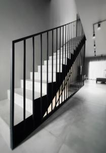 Una escalera con barandilla negra en una habitación. en Luxury Beach Villa, en Adeje