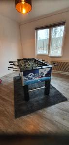 a ping pong table in a living room with a table at Landhaus Lönneberga in Lönneberga