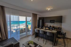a kitchen and living room with a view of the ocean at Stegna Sea & Sun in Archangelos