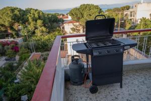 a grill with a laptop on top of it on a balcony at Zoumperi Nea Makri 4-5 guest apt big balconies 5 min to beach in Nea Makri