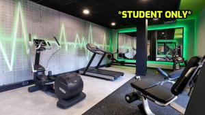 a gym with several tread machines and a sign that readsstudent only at Student Only Zeni Ensuite Rooms, Southampton in Southampton