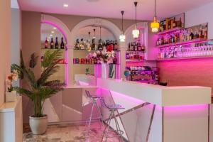 bar z różowym oświetleniem w pokoju z rośliną w obiekcie HOTEL la SERENISSIMA TERME & SPA w mieście Abano Terme
