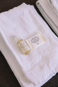 a bottle of soap sitting on top of a white towel at Casa da Maria Alfama in Lisbon