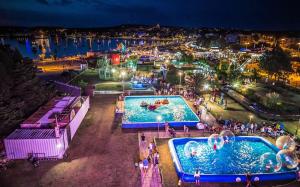 an overhead view of a water park at night at Apartments Riva in Medulin