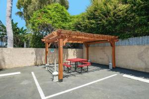 a picnic table and chairs under a wooden pavilion at Hyland Inn near Legoland in Carlsbad