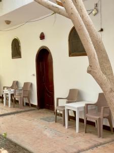 a group of tables and chairs in front of a building at Red oasis in Dahab