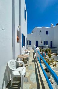 a row of chairs and tables on the side of a building at Marina In Town in Megali Ammos