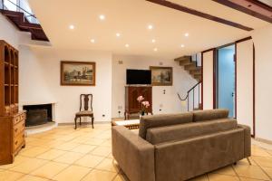 a living room with a couch and a fireplace at Palazzo Barone in Bari