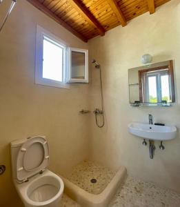 a bathroom with a toilet and a sink at Marina In Town in Megali Ammos