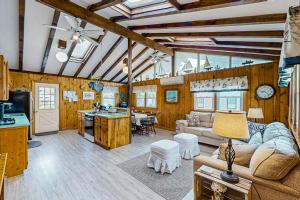 a living room and kitchen with wooden walls and ceilings at Spirit of the Sea in Mashpee