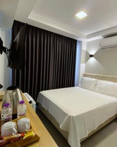 a hotel room with a bed and a television at The Brothers Suite Dalaman in Dalaman
