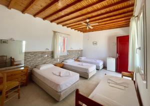 a bedroom with three beds in a room at Marina In Town in Megali Ammos +41 photos