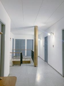 a white room with a balcony with a pole at La casa frente al parque in Mendoza