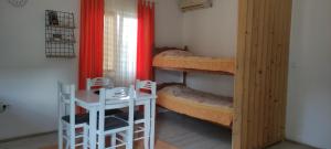 a room with two bunk beds and a table and a desk at Apartman in Nikšić