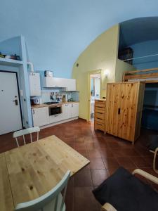 a kitchen with a wooden table and a dining room at CASA ELENA in Sanremo