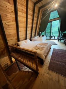 a bedroom with a bed in a wooden room at Çınar suit bungalov in Çamlıhemşin