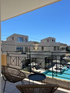 a view of a balcony with chairs and a pool at Melina's Apartments in Nea Kydonia