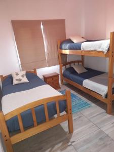 Zimmer mit 2 Etagenbetten in einem Zimmer in der Unterkunft Casa Nera in Esquel