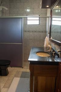 a bathroom with a sink and a toilet at Hospedaria Santa Clara - Serra Catarinense in Bom Retiro +27 photos