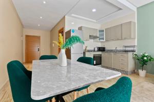 a kitchen and dining room with a table and chairs at Serene One Bed Oasis in the Heart Of The Medina in Les Camps