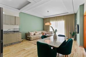 a kitchen and a living room with a table and chairs at Serene One Bed Oasis in the Heart Of The Medina in Les Camps +10 photos