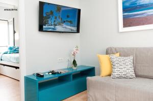 a living room with a blue table and a couch at Hotel Apartamento Bajamar in Las Palmas de Gran Canaria