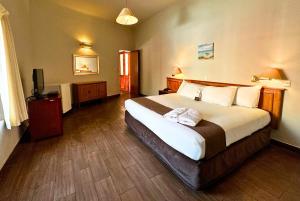 Postel nebo postele na pokoji v ubytování DM Hoteles Mossone - Ica