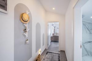 a hallway with white walls and a floor with a rug at Meri Suite Apart Kaş in Kas +122 photos