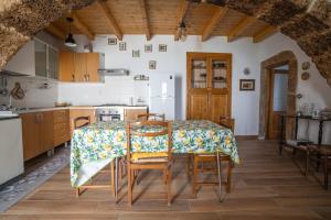 a kitchen with a table and chairs in a room at Home at Calascio in Calascio