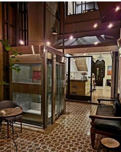 a room with a table and chairs and a kitchen at Hotel Costa Rica in Buenos Aires