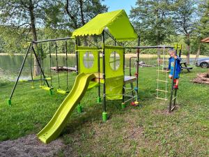 a young boy is playing on a playground at IguHouse in Czaplinek