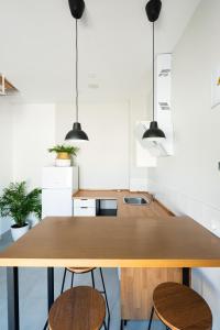a kitchen with a wooden table and two stools at Villa 25 in Cabra