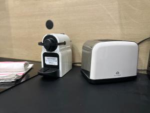 a toaster and toaster sitting on a counter at Orléans Centre - LOVE ROOM - Good Vibes Only in Orléans