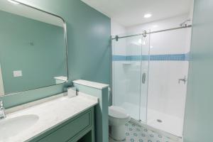 a bathroom with a shower and a sink and a toilet at Lake View Hotel in Mackinac Island +20 photos
