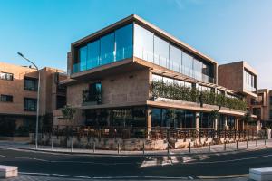een gebouw met een restaurant in een stadsstraat bij M Boutique Hotel - Designed for Adults in Paphos City