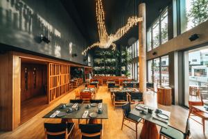 a restaurant with tables and chairs and a chandelier at M Boutique Hotel - Designed for Adults in Paphos City