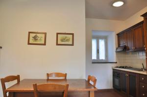 a kitchen with a table and chairs in a kitchen at Montecasciano - Rosa in Capranica