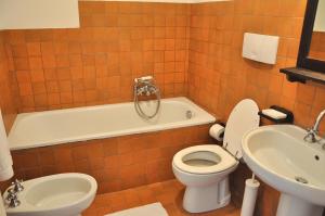 a bathroom with a toilet and a tub and a sink at Montecasciano - Girasole in Capranica +37 photos